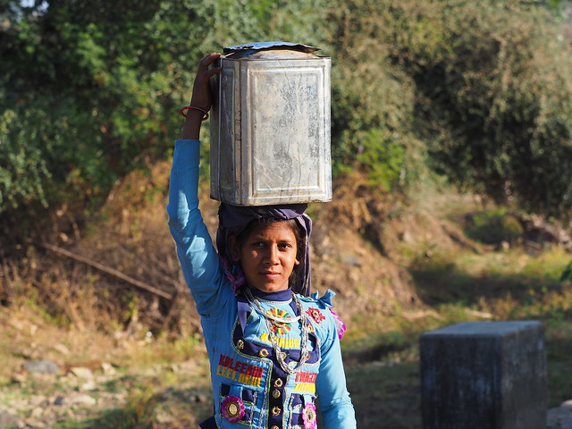 Garasia girl carrying water