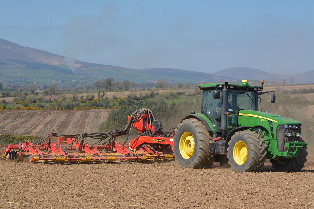 John Deere 8345R Tractor with a Vaderstad Carrier 1225 Cultivator