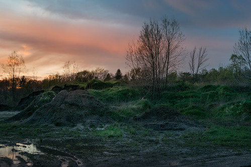 the emerald pile by Christian Collins, A dirt pile that has been around for years, it seems to grow and shrink as shops and apartments have
