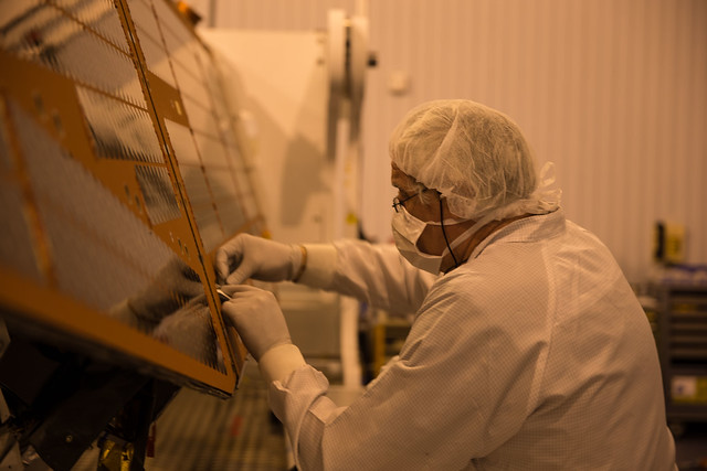Removing protective covers from the Swarm solar arrays
