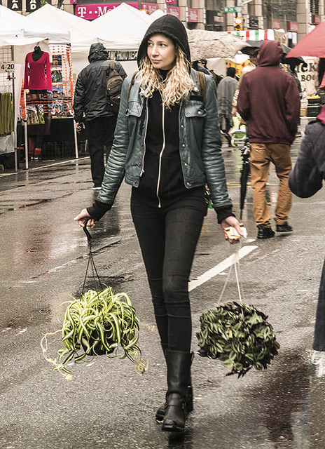 Girl Holding Planters and Walking Along Street Festival In Manhattan