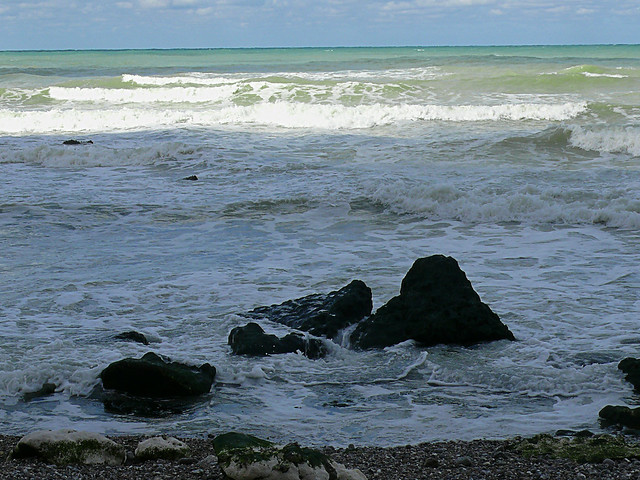 2007.09 -  'A sunny sea-scape of splashing surf and rocks', on the shore of Petit-Dalle in Normandy France with a quiet sea; French landscape photography, Fons Heijnsbroek