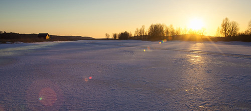 Sunset river by Joni Mansikka, Februarywinter nature river ice snow outdoor riverbanks trees sunset light flares sky colours landsc