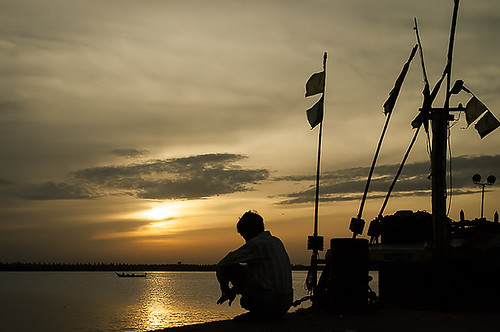 street sea sky sun man water silhouette yellow clouds sunrise boat harbour royapuram