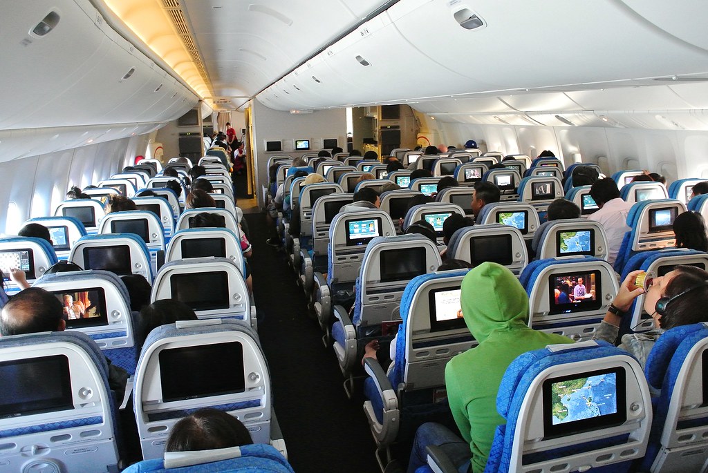 The Economy Class Cabin Of A Cathay Pacific Airways Boeing