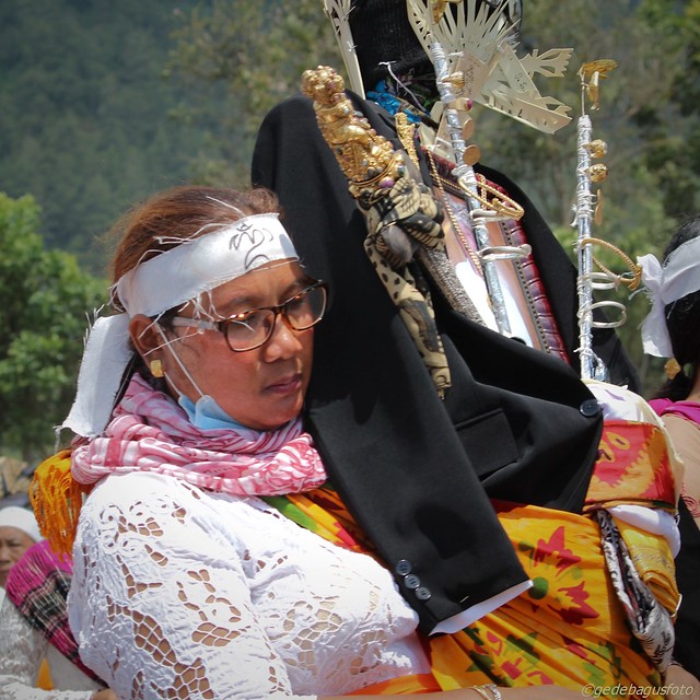 Balinese woman carrying cremation effigy
