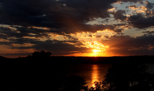Sunset over the River by froggieb, sunset orange yellow clouds nightsky sunbeams