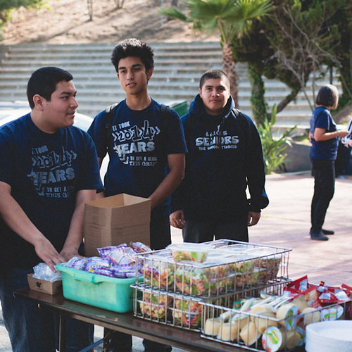 A group of students gathered together at a table - Find Food, Shelter & Other Resources In Your Community