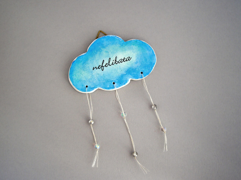 Nefelibata cloud, A clay cloud painted blue with the word …