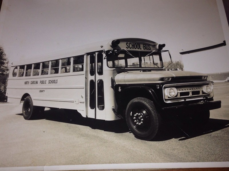 THOMAS BUILT BUS, 1963 Chevrolet.  Brand new (orange) NC school bus before county name & bus number was added. Digitized photo of print.