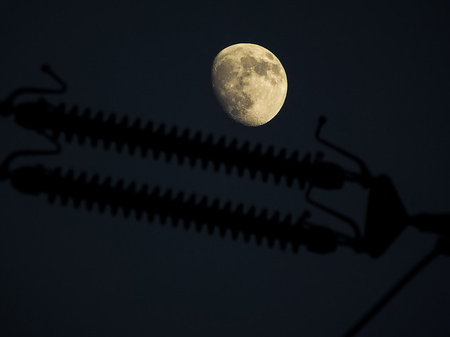 Moon on electricity pylon