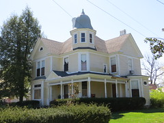 Yellow Queen Anne house with corner cupola