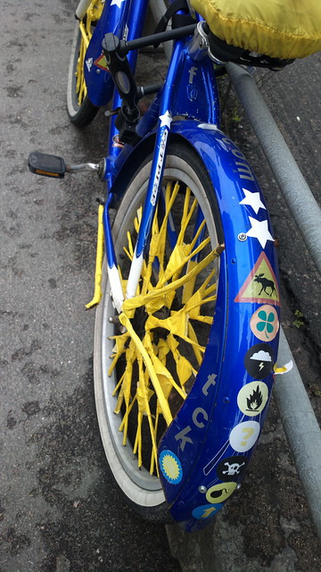 Bikehack: stickered mudguard and yellow taped up spokes and kickstand