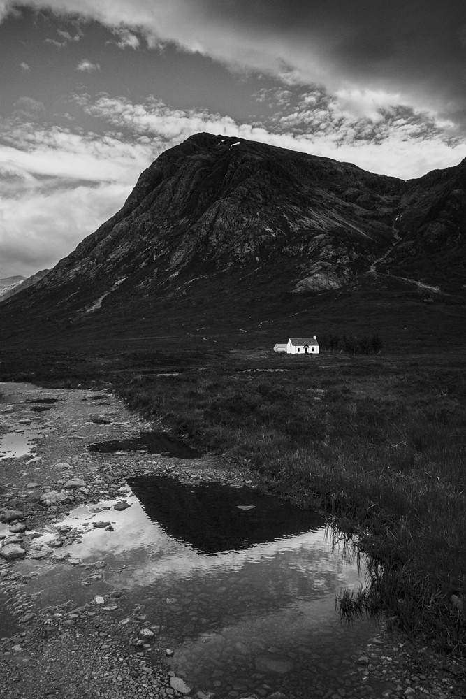 Little white house against a mountain in Scottish Highlands, Scotland