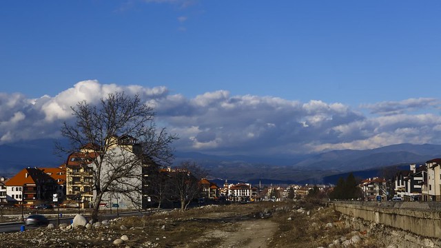 Ligth and shodows moving over the city of Bansko and mountains
