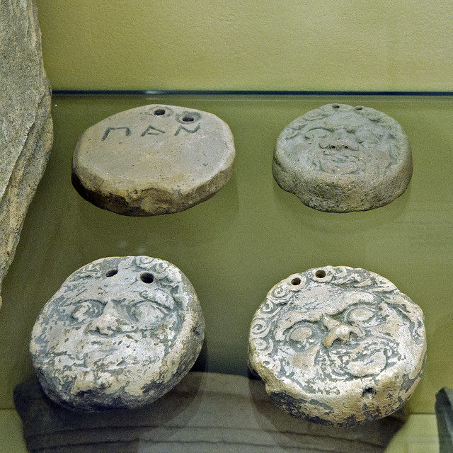 Terracotta loomweights with gorgoneia in relief, one inscribed PAN