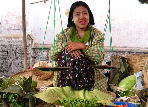 Selling green vegatables , dressed in Green
