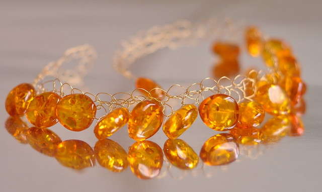 Necklace - Baltic amber nuggets in crocheted golden brass net - Made by the Sun