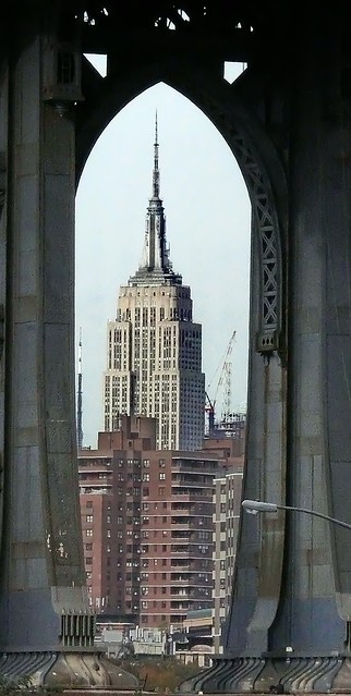 Empire State building viewed  thru Manhattan Bridge support