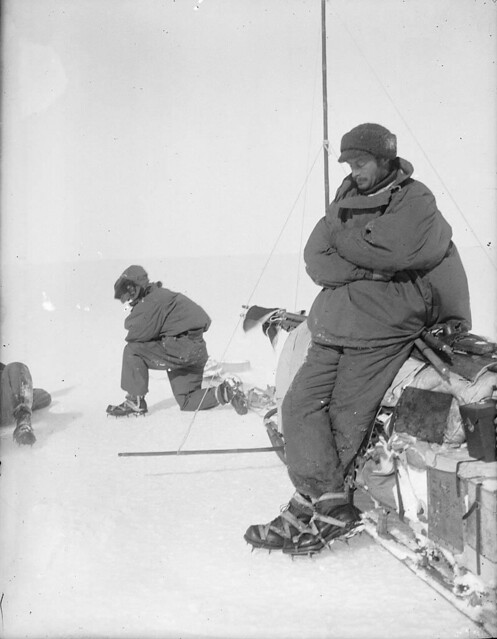 Mawson rests at the side of sledge, outward bound on first sledge journey in Adelie Land