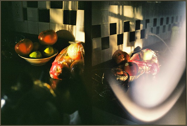 Two tomatos, two limes and some apples on my kitchen counter