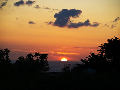 Alderney Sunset by neilalderney123, The Sun sits on the horizon, showing the silhouettes of distant clouds, over the Atlantic Ocean.
Thi