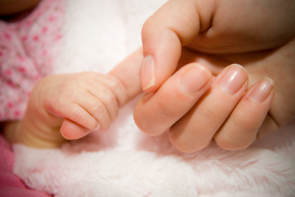 Newborn hand, mom hand