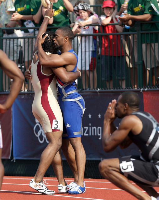 Men's 100M winner Tyson Gay (center)
