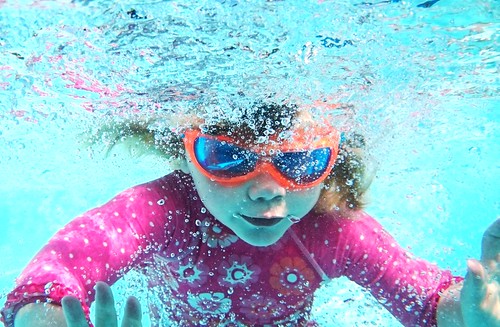 Child wearing goggles in a Cedar Park, TX pool.