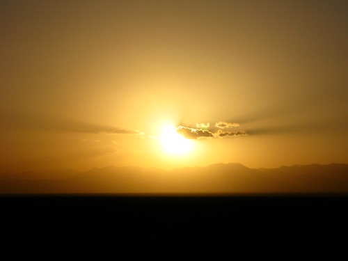 Sunset east of Shanshan over the Tianshan mountain range as seen from National Highway 312, Xinjiang, China by Robert Thomson, Cycling and skateboarding 20,000km solo around the world - check out the fully featured website at <