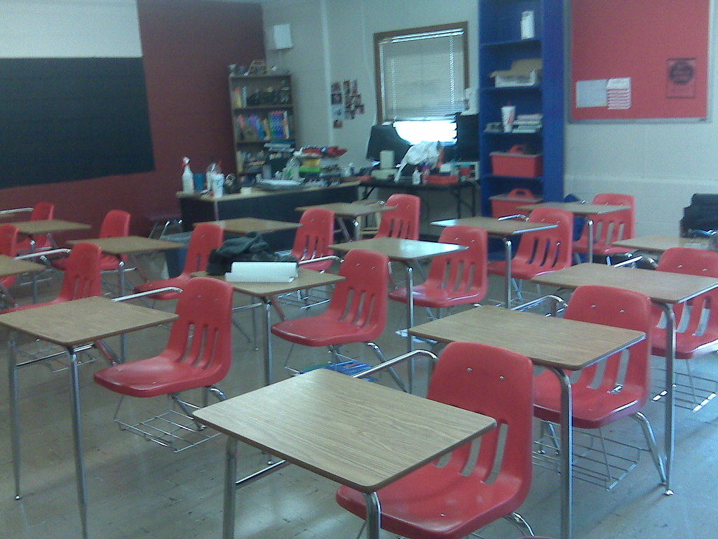 High school classroom with red desk chairs
