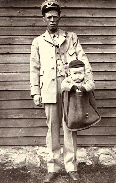 Uniformed Letter Carrier with Child in Mailbag