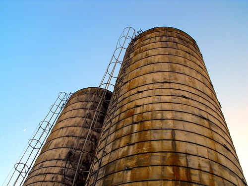 old blue sky standing high still rust farm silo rusted worn weathered silos ladder skyhigh greeneyephoto