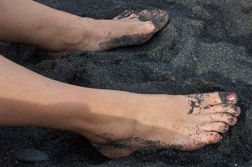 Lisa's feet on the black sand beach | JHill | Flickr