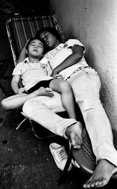 woman and child sleeping in street - Bangkok, city of angels