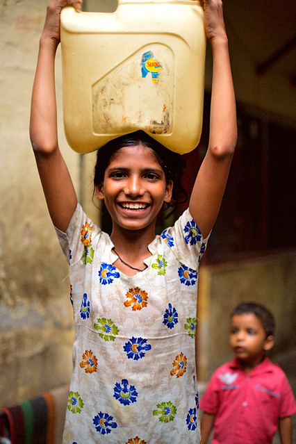 Girl carrying water - Delhi