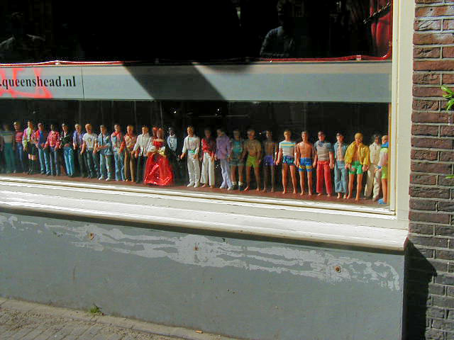 ken dolls in a bar window