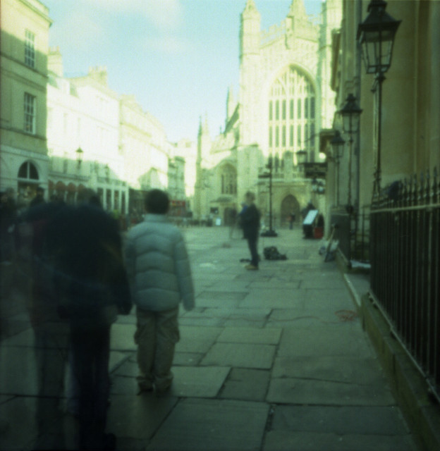 Pinhole shot of a performer outside Bath abbey