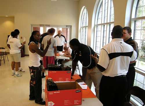 Our football coaches help their players check-in