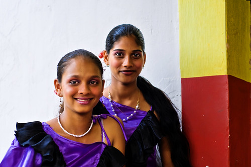 In Goa at Bonderam, Two Girls smile and wait for their turn to dance ! by Anoop Negi