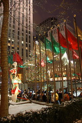 Flags, giant toy soldiers, and the NYC Christmas Tree above the skating rink at Rockefeller Center