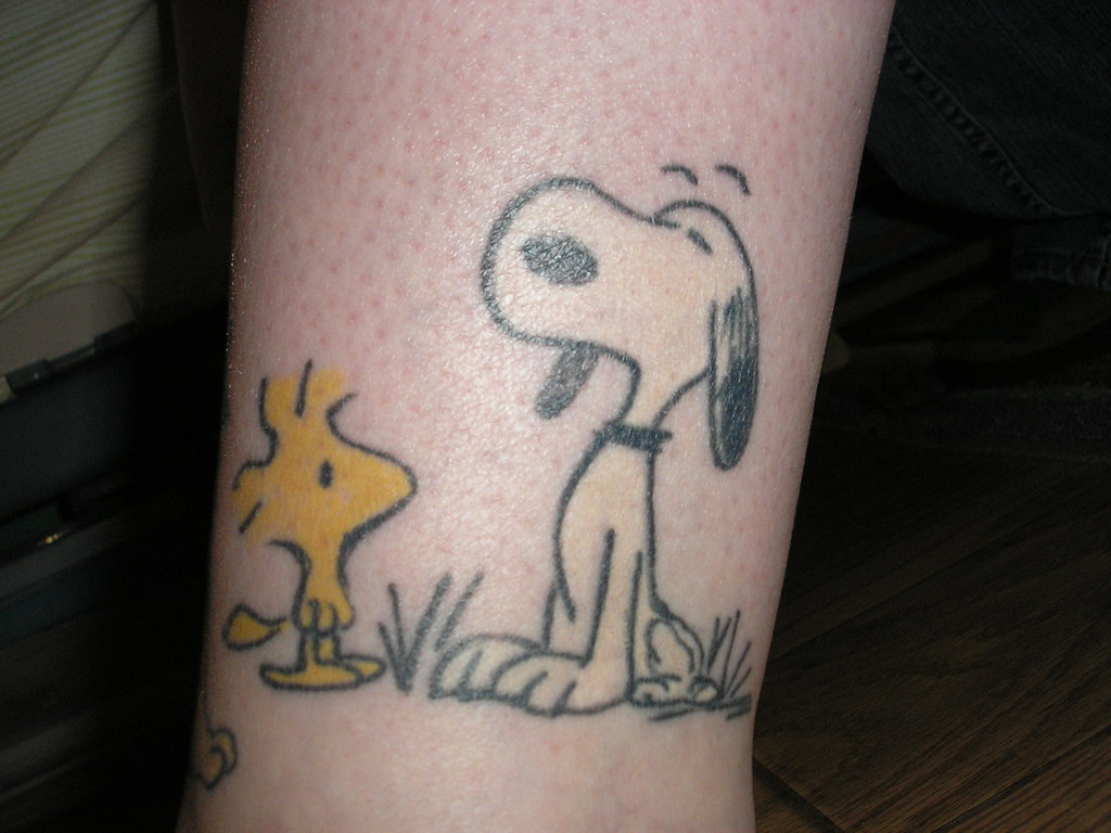 Snoopy and woodstock tattoo located on the inner arm
