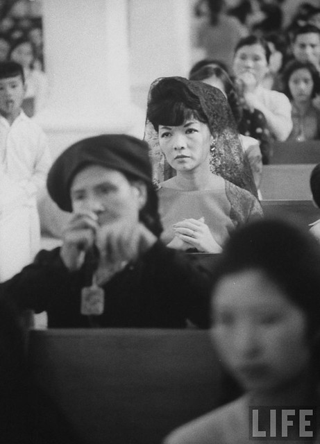 7-1962 Mrs. Dinh Nhu Ngo, Vietnams's First Lady, (Rear) praying in church.