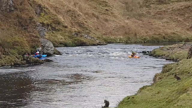 Surfing a wave in Dirlot Gorge, Thurso River.