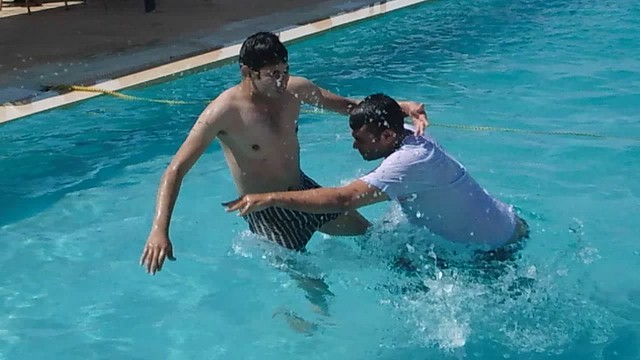 some friends fight at swimming pool with funny way