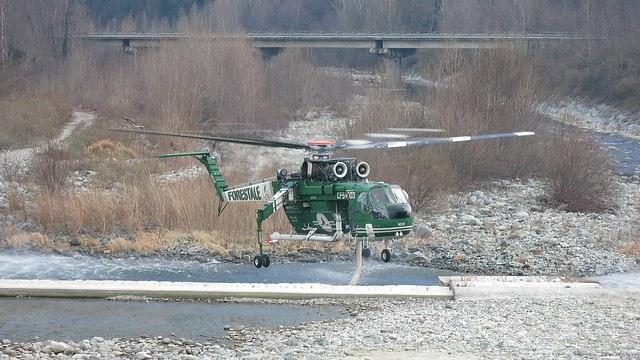 Forestry helicopter engaged in fire extinguishing operations