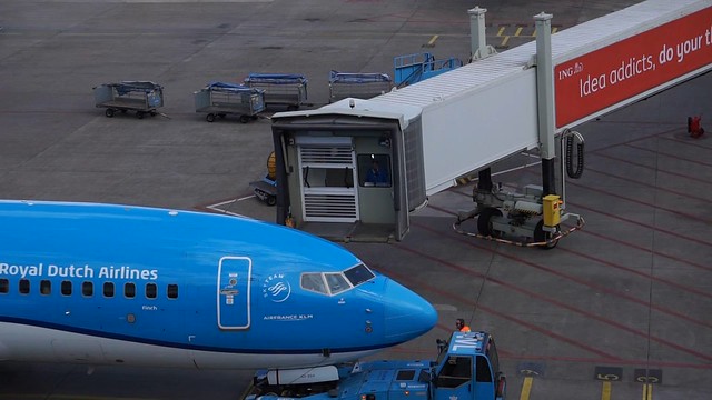 Pulling back the jetway by a senior KLM stewardess.
