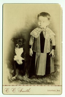 Child with lace collar, posed with dog | by George Eastman Museum