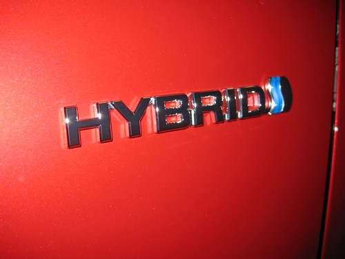 Toyota Hybrid logo on a red vehicle in Panama City, Florida.