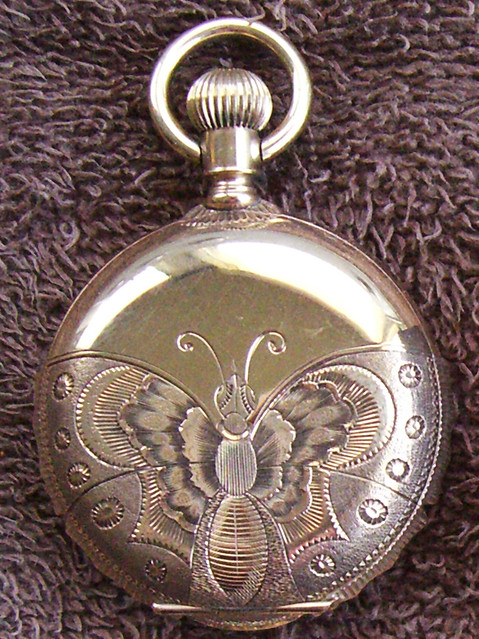 Hand engraved butterfly on a watch